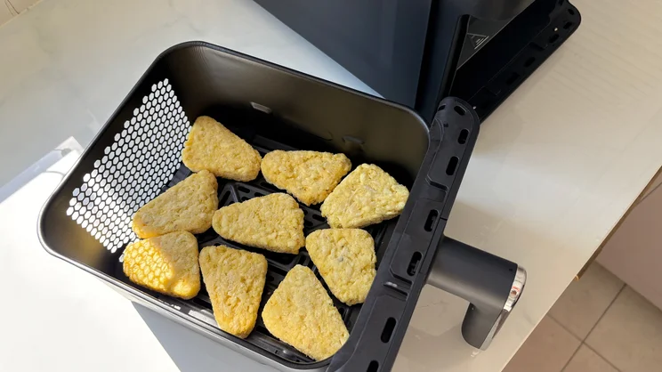 Frozen hash browns in a drawer of the Tower Vortx 11 Litre Dual Layer air fryer