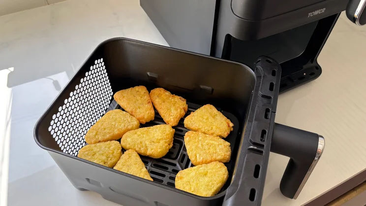 Cooked hash browns inside a drawer of the Tower Vortx 11 Litre Dual Layer air fryer
