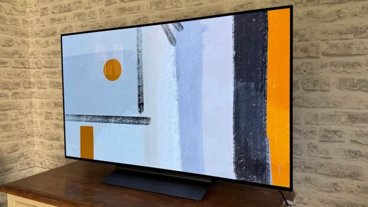 The LG C5 OLED TV on a wooden TV cabinet