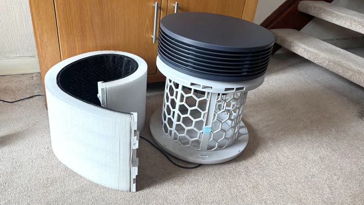 The Blueair Signature air purifier with filter removed, on the floor in a home