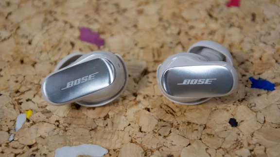 The Bose QuietComfort Ultra Earbuds 2nd Gen on a cork table