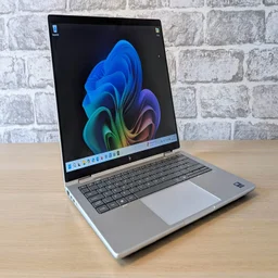 The HP EliteBook X Flip G1i in traditional laptop configuration on a wooden desk
