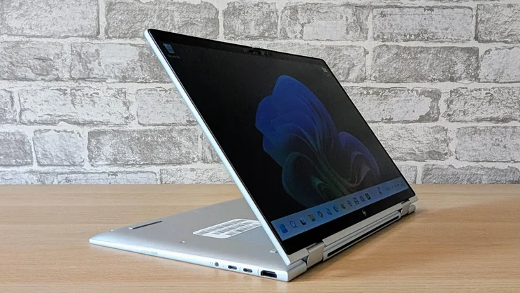 The HP EliteBook X Flip G1i in touchscreen viewing configuration on a wooden desk