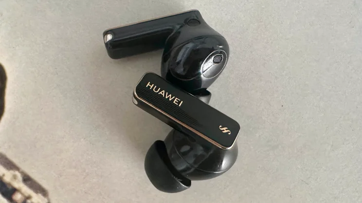 The Huawei FreeBuds 4 Pro wireless earbuds side by side on a white table