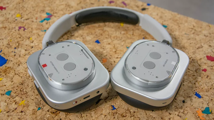 Front view of the Nothing Headphone (1) lying flat on a cork table