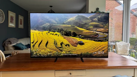 Front view of the Sony Bravia 9 Mini LED TV displaying a screensaver while located on a wooden table in a kitchen