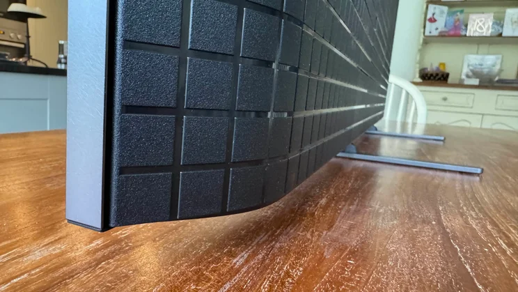 Side view of the Sony Bravia 9 Mini LED TV showing the depth of the panel and the stand feet the television sits on