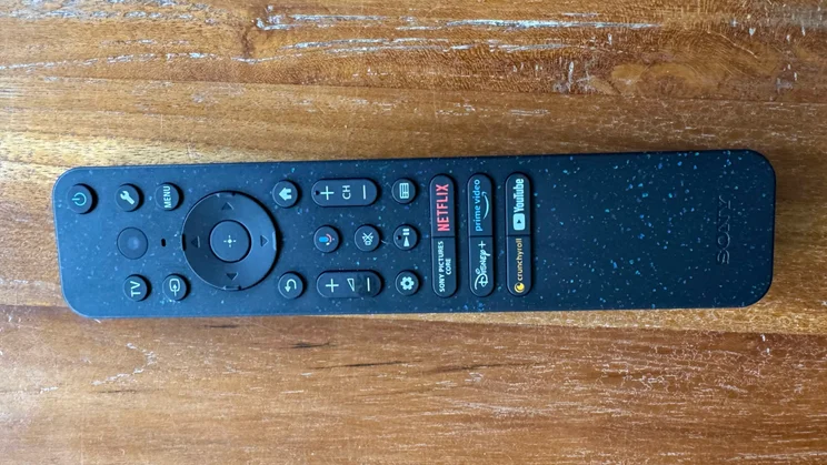 One of the two remote controls included with the Sony Bravia 9 Mini LED TV on a wooden table
