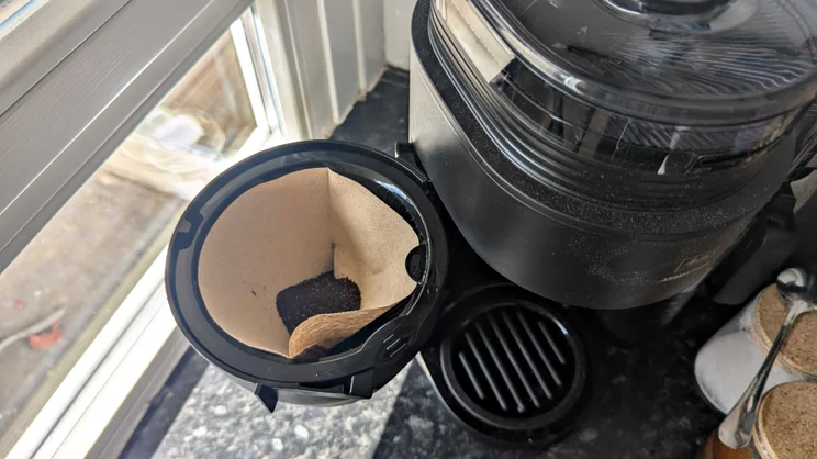 A picture of the Melitta AromaFresh Therm Pro's coffee filter drawer opening to the side