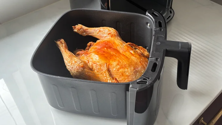 A roast chicken after having been cooked in the Bosch Series 6 Air Fryer