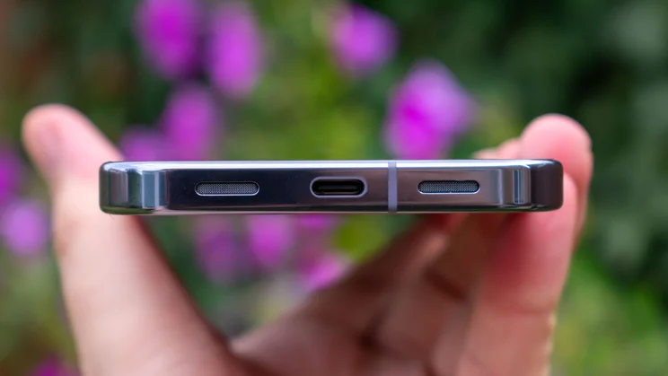 Google Pixel 10 Pro XL in hand, showing the bottom edge and charging port