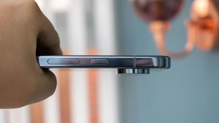 Google Pixel 10 Pro in hand, showing the power and volume buttons
