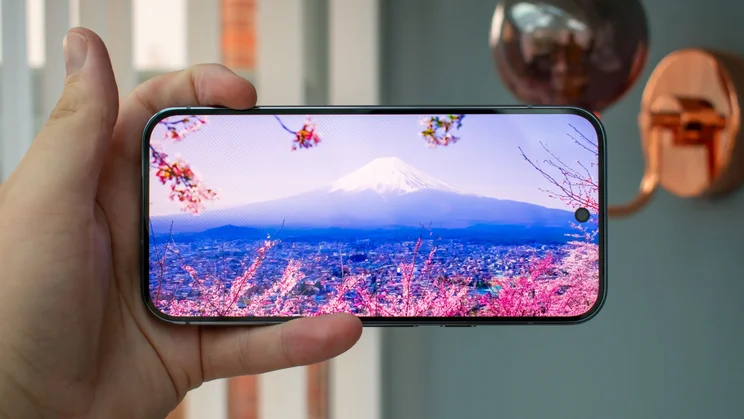 Google Pixel 10 Pro in hand, showing a video on the display