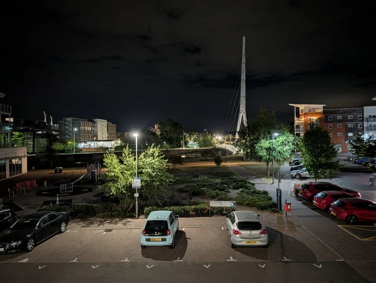 An apartment complex and car park at night