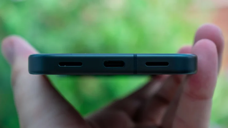Google Pixel 10 in hand, showing the bottom edge and charging port