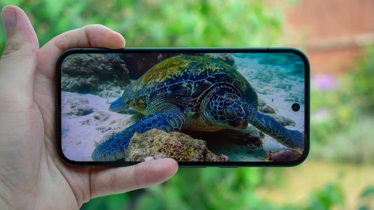 Google Pixel 10 in hand, showing a video on the display