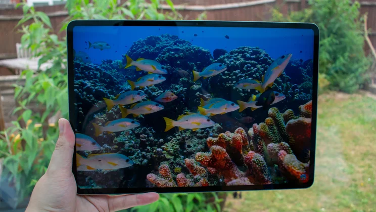 Honor Magic Pad 3 in hand, showing a video on the display