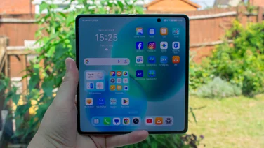 Honor Magic V5 in hand, unfolded with the display on