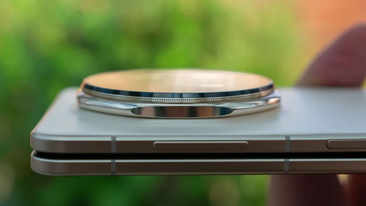 Honor Magic V5 folded in hand, showing the thickness of the camera housing