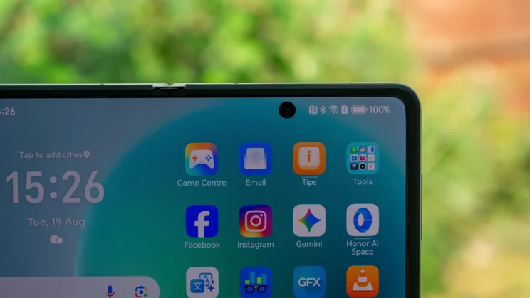 Honor Magic V5 in hand, showing the internal selfie camera
