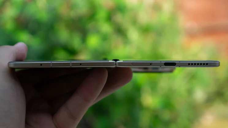 Honor Magic V5 in hand, showing the bottom edge