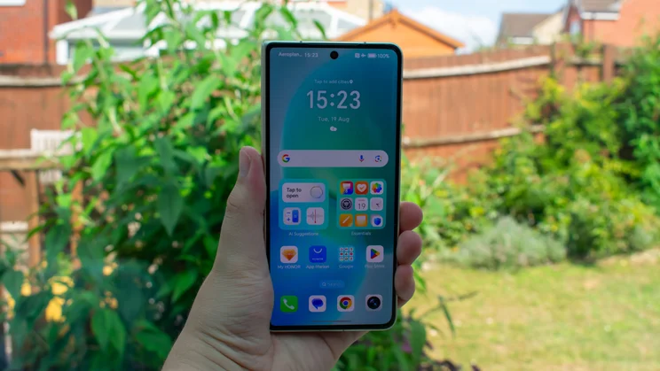 Honor Magic V5 in hand, folded, with the external display on