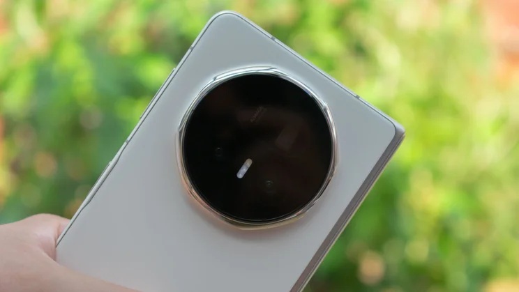 Honor Magic V5 folded in hand, showing the rear cameras
