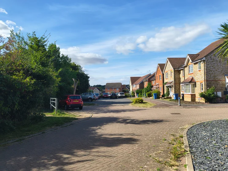 A quiet close of houses with cars parked out front