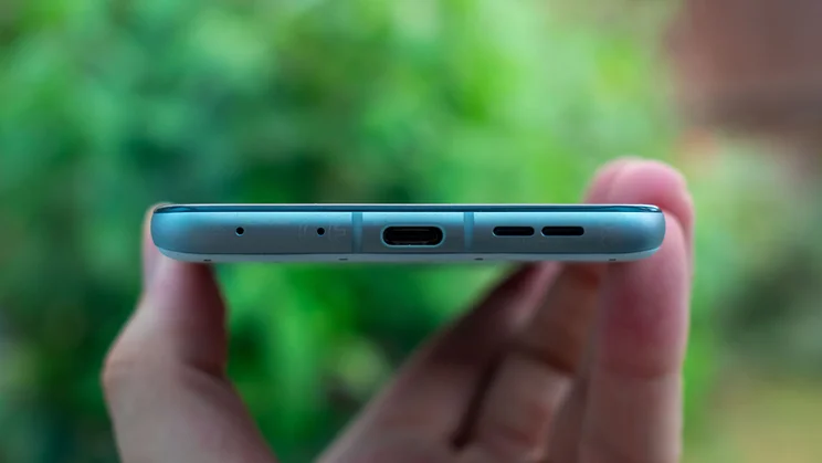 Motorola Razr 60 in hand, showing the bottom edge and charging port