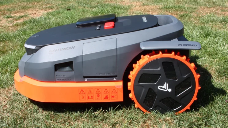 The Segway Navimow X350E, sitting on a lawn, from the left side