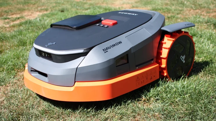 The Segway Navimow X350E, sitting on a lawn, shot from the front left corner