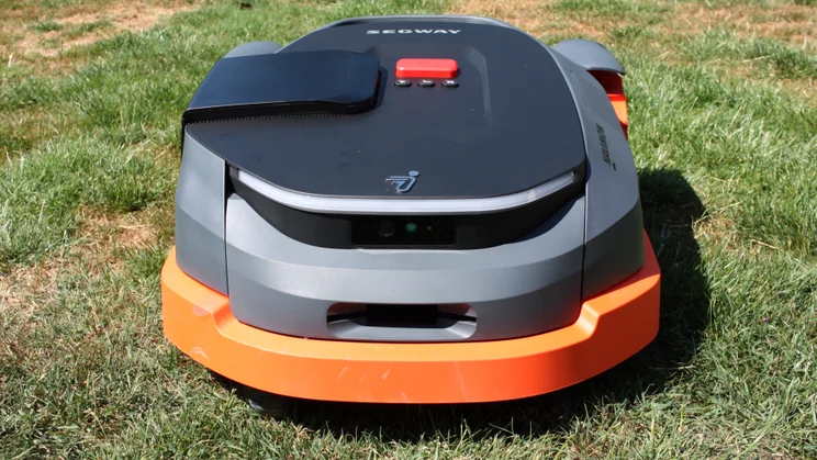 The Segway Navimow X350E, sitting on a lawn, pcitured from the front