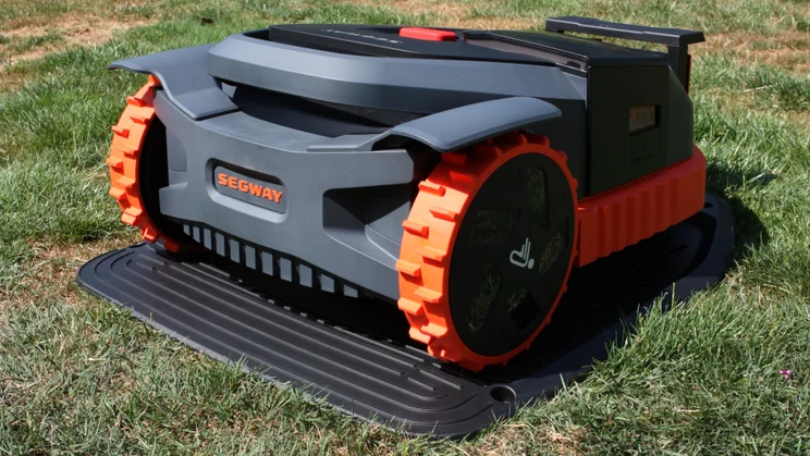The Segway Navimow X350E, sitting on a lawn, pcitured from the rear right