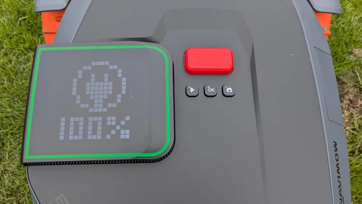A close up of the Segway Navimow's top panel buttons and screen