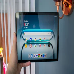 OnePlus Pad Lite in hand, front view, with the display showing the homescreen