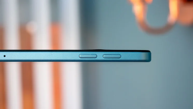 OnePlus Pad Lite in hand, close up of the edge and volume buttons