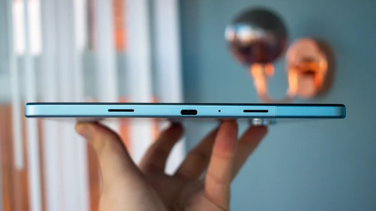 OnePlus Pad Lite in hand, showing the bottom edge and charging port