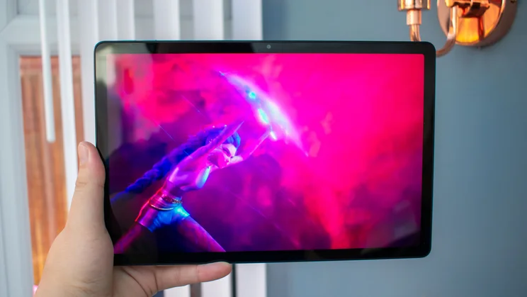 OnePlus Pad Lite in hand, front view, showing a colourful animation on the display