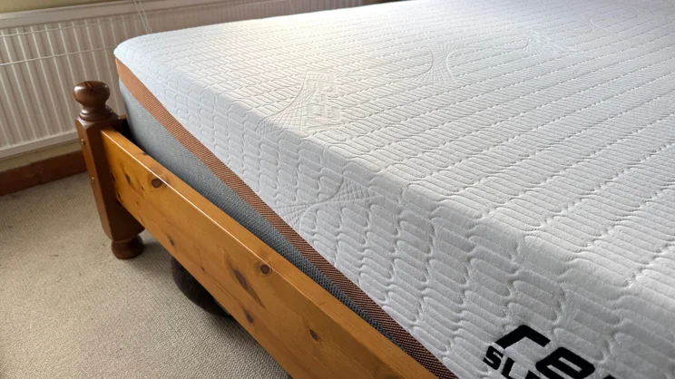 A medium shot of the corner of the REM-Fit 600 Lux Elite mattress, on a wooden bed frame