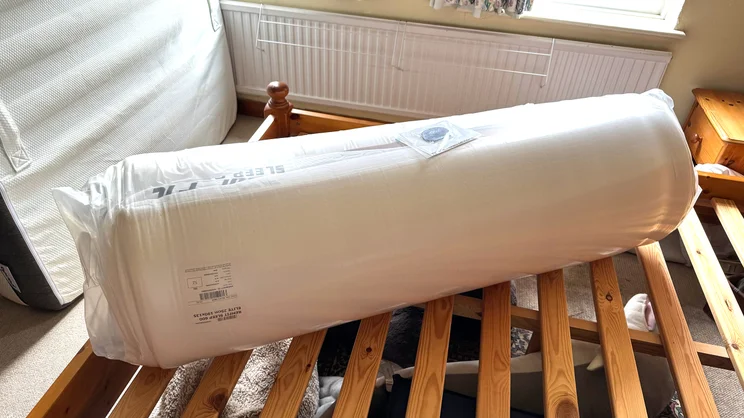 The the REM-Fit 600 Lux Elite mattress rolled up and vacuum sealed