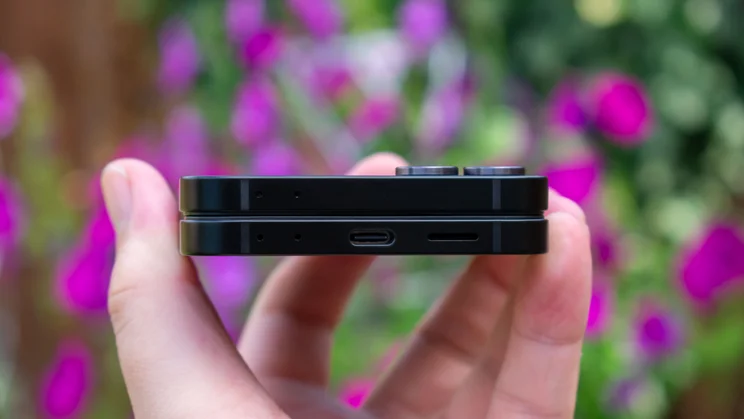 Galaxy Z Flip 7 FE folded in hand, showing the bottom edge and charging port