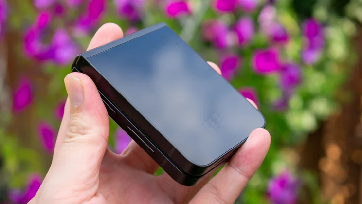 Galaxy Z Flip 7 FE folded in hand, angled rear view