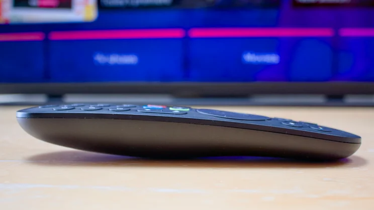 A side view of the Sky Glass Air Bluetooth remote control in front of the Sky Glass Air TV