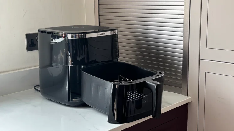 The Bosch Series 6 Air Fryer on a kitchen worktop pictured with its drawer extended