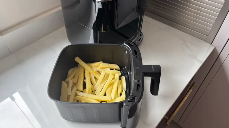 The drawer of the Bosch Series 6 Air Fryer holding some uncooked fries