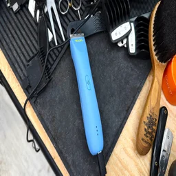 The Wahl Peanut Li trimmer charging on a barber's worktop
