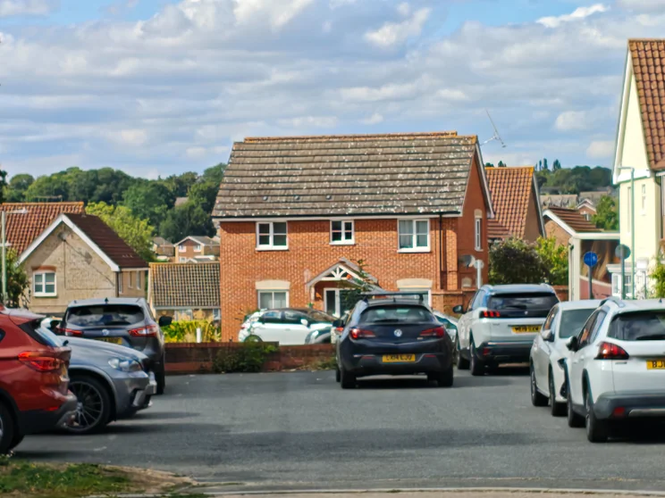 5x zoom of houses with cars parked out front