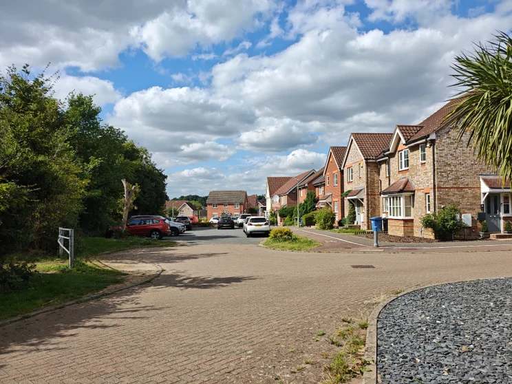 A quiet close of houses with cars parked out front