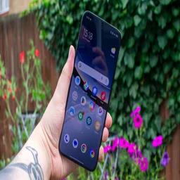 Xiaomi Poco F7 in hand, front view with the display on