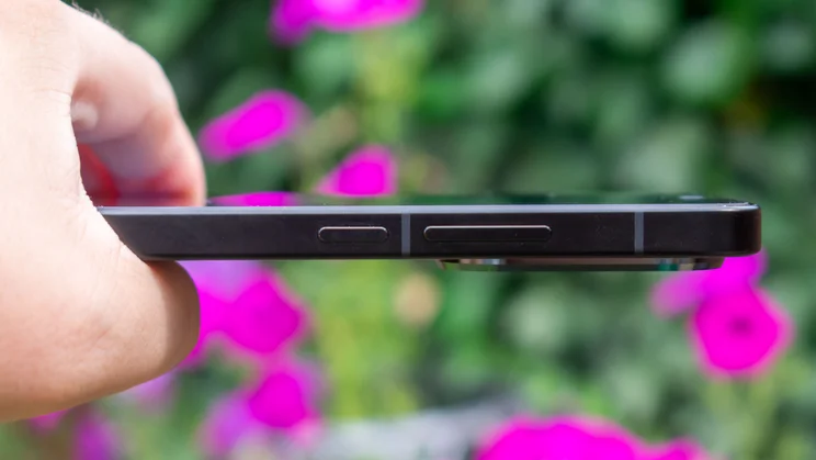 Xiaomi Poco F7 in hand, showing the power and volume buttons